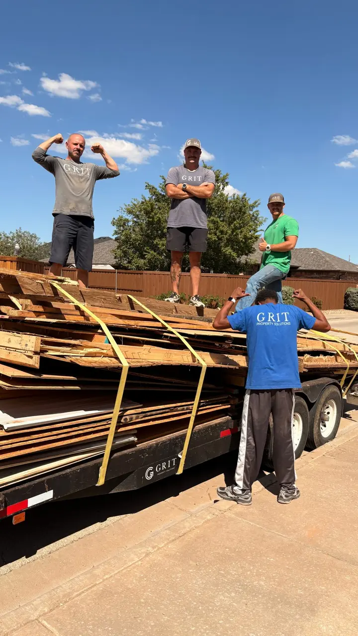 GRIT crew on top of a trailer loaded with demolition debris