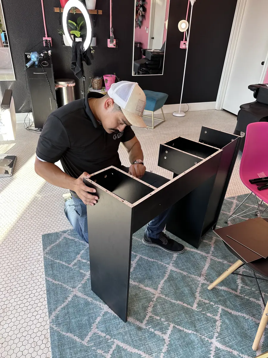GRIT team member assembling a cabinet inside a customer's space
