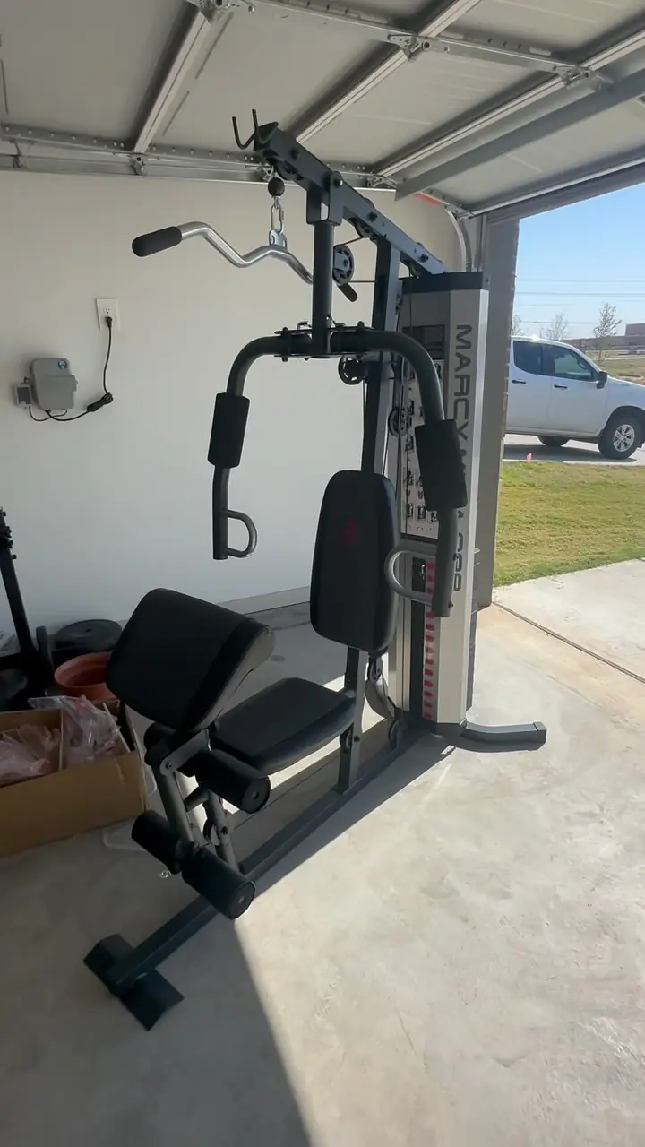 Garage in Lubbock cleared out by GRIT, with home gym equipment left in place