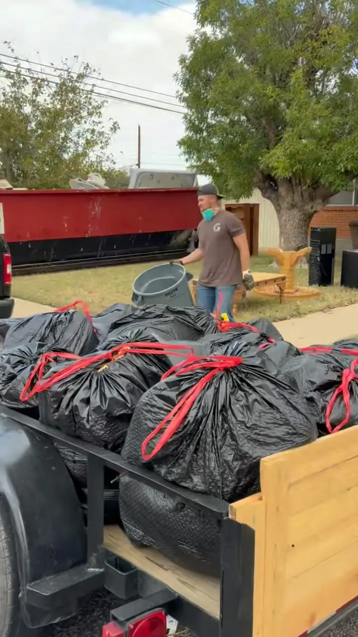 Trailer loaded with bagged junk during a Lubbock property cleanout