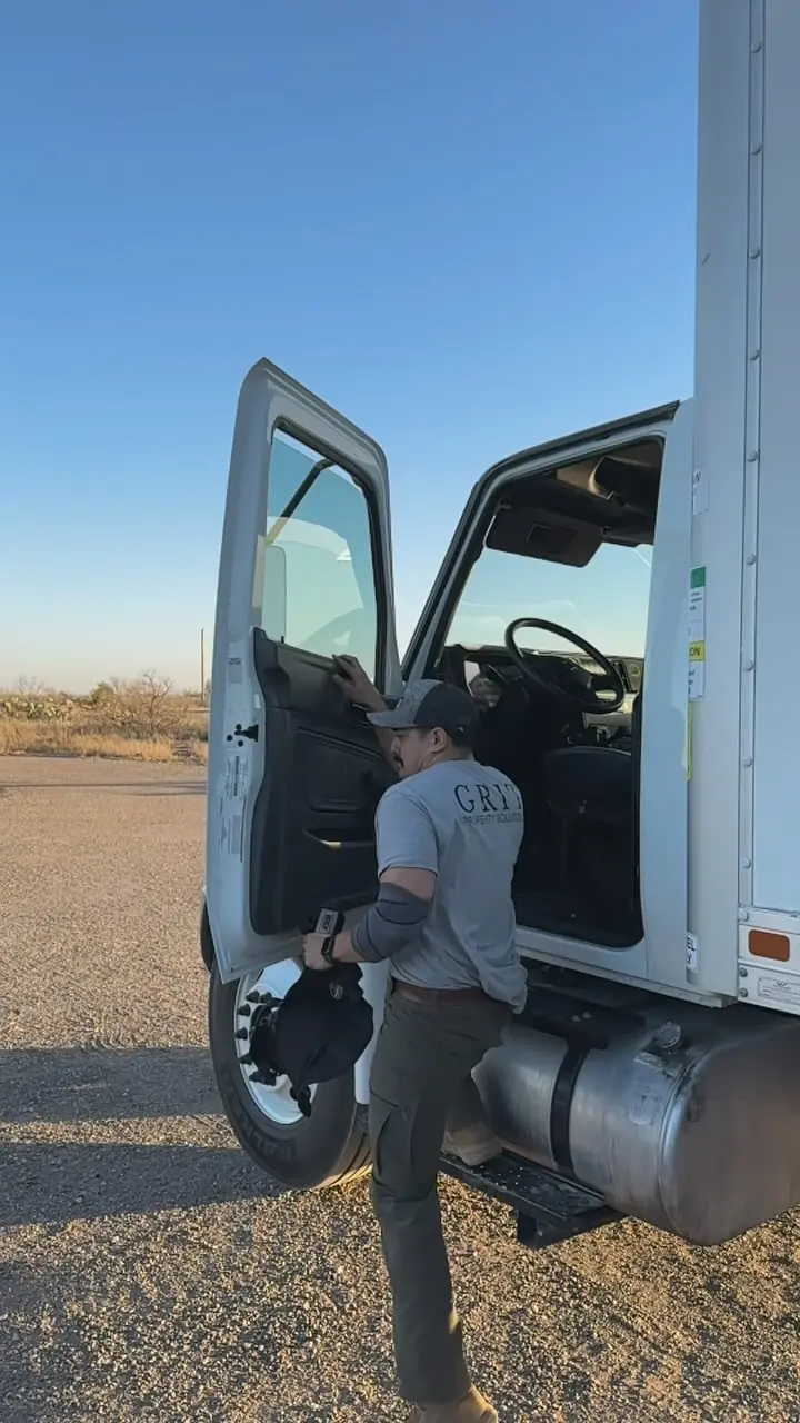 GRIT mover climbing into the cab of a box truck before a long drive
